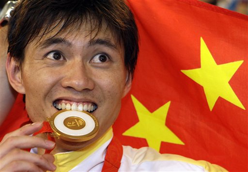 Photo: Zhong Man bites his gold medal after winning