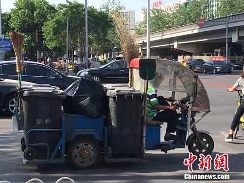 资料图:北京朝阳区劲松街道附近的垃圾车。 垃圾分类推行17年效果不佳 46城市将强制实施