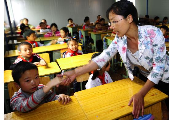 图文:老师在安慰失去母亲的小学生