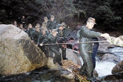 13日清晨，救援人员抬着牺牲民警张宁海的遗体下山。廖福安 王波/摄 资料图