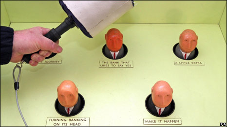 A fairground game involving beating banker dolls.