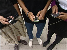 People using mobile phone to text