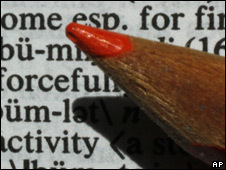 A red pencil on a dictionary page