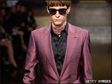 A model at London Fashion week wearing a purple suit