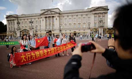 Chinese tourists outside Buckingham Palace. Their deputy prime minister has warned them about bad behaviour overseas