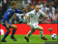 Alexndr Kislitsyn of Kazakhstan chases England's Wayne Rooney