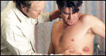 A doctor examining a man with a rash