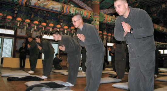 驻韩美军的50余名官兵正在庆南陕川海印寺法堂中进行礼佛