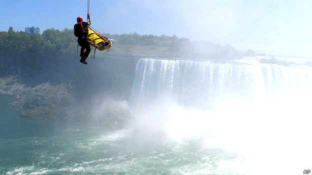 Emergency workers rescue a man who fell into Niagara Falls in Canada