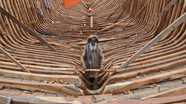 A Pakistani carpenter working on a boat