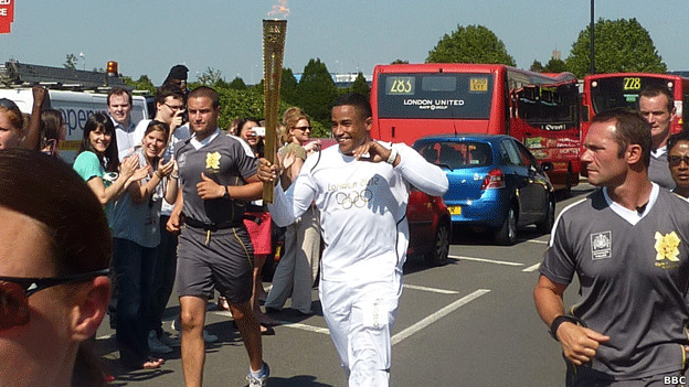 A man carrying the Olympic torch.