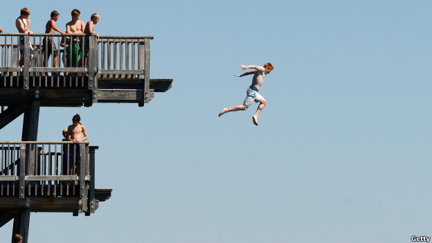 A boy jumps from a diving platform in Germany.