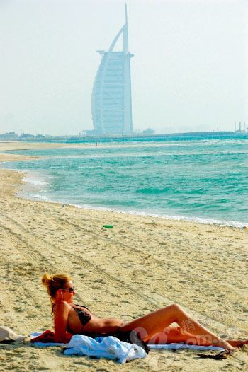 Bikini girl in the Seven Stars Hotel on the beach sunbathing