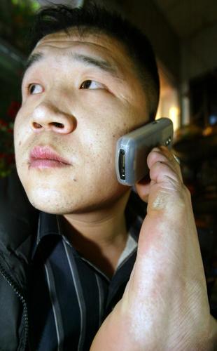 王建海双脚的柔韧性极好,正在打电话