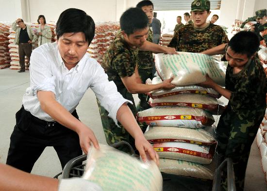 图文孙达华同解放军官兵一起从粮库中搬运捐赠的大米