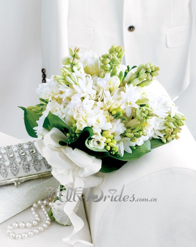 这款用八仙花,小苍兰以及玉簪属植物制成的新娘捧花,白色花朵与淡绿色